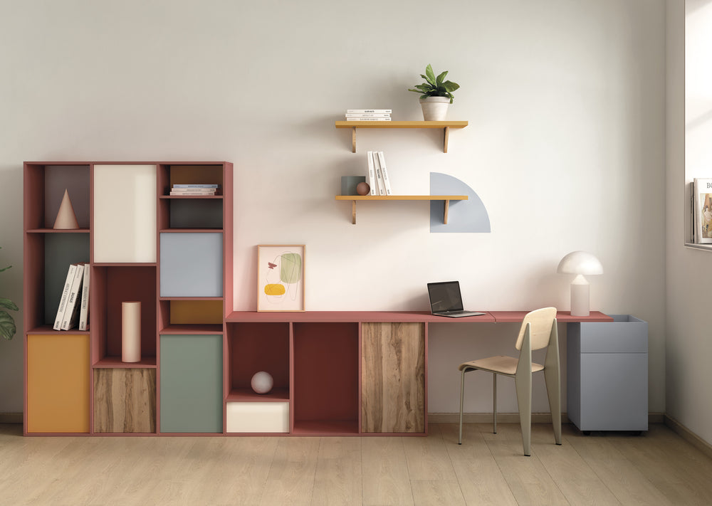 Modern home office with a colorful bookshelf, desk, and chair.